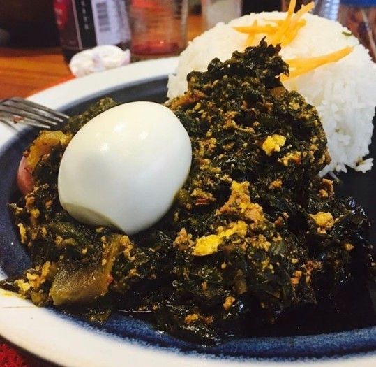 Plain rice with kontomire stew and egg